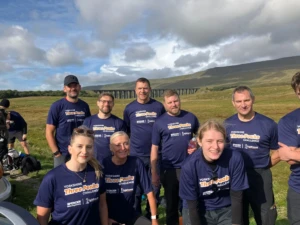 A group photo of people taking on the three peaks challenge