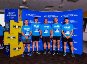 An image of a group of people stood in front of a board