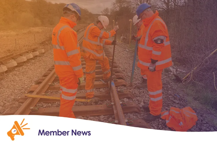 An image of three people working on a railway line