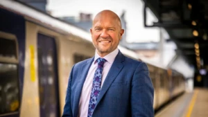 An image of a man stoof in front of a train