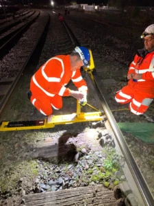 Two men fixing a railway track