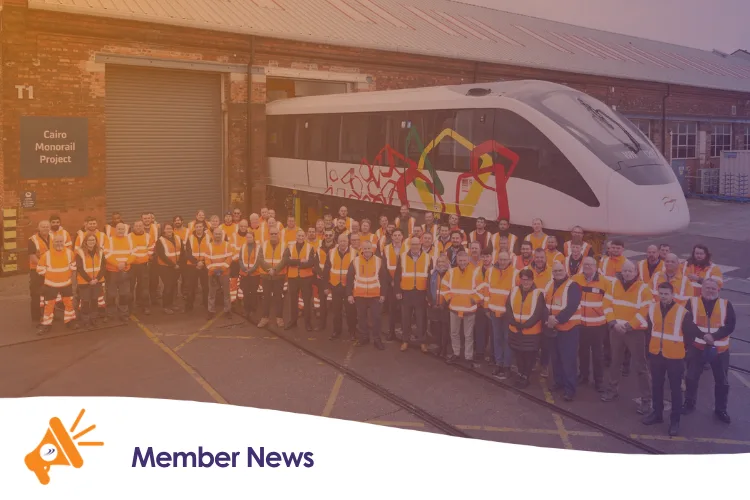 A team of workers stoof next to a train