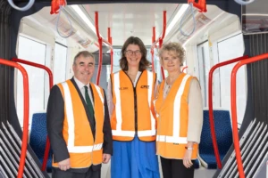 Three people stood in a train