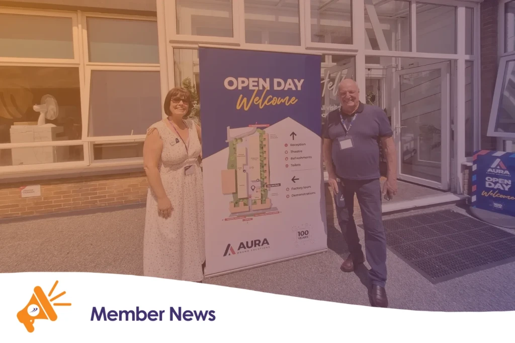 Two people stood in front of an open day sign