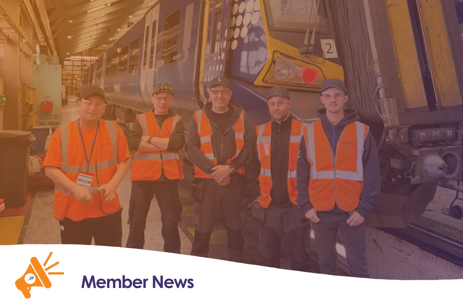 A group of people stood next to a train
