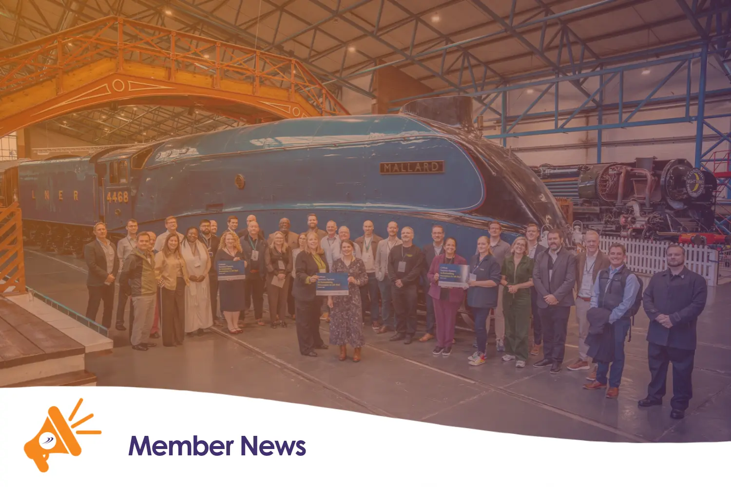 A group of people stood next to the Mallard train