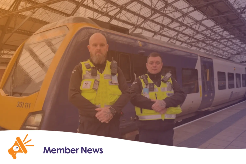 Two security officers stood in front of a Northern train