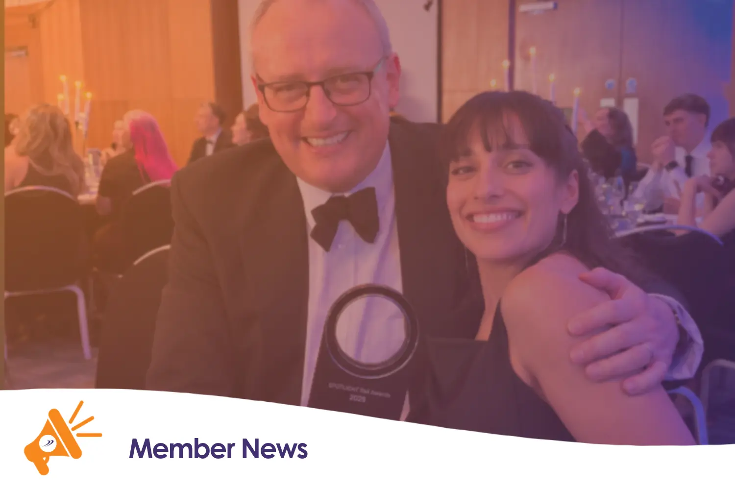 Two people holding an award